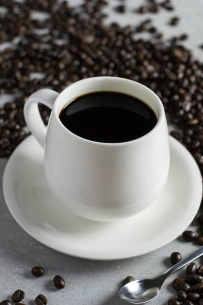 istock White glass of coffee with coffee bean on a stone table. 690492904