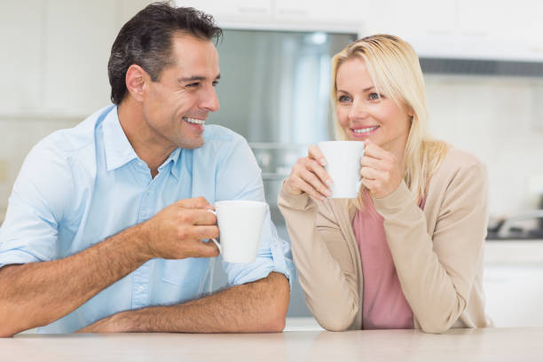 istock Happy couple with coffee cups in kitchen 690496056