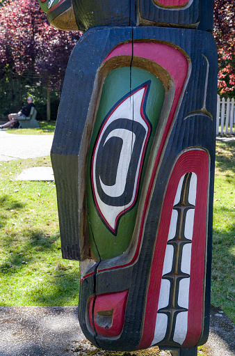 VICTORIA,BC CANADA SEPTEMBER 1,2013: Totem poles in Thunderbird park carved by indigenous Canadians. The park is part of the Royal BC Museums. All but two of the totem poles in the park are replicas carved by indigenous artists hired by the BC Museum as part of the pole restoration project.