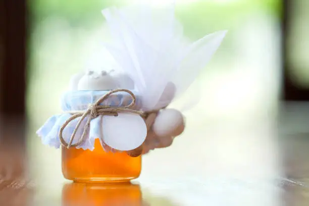 Wedding favor with jar of honey.