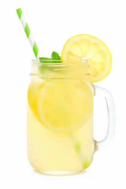 Photo of Mason jar of lemonade with straw isolated on white