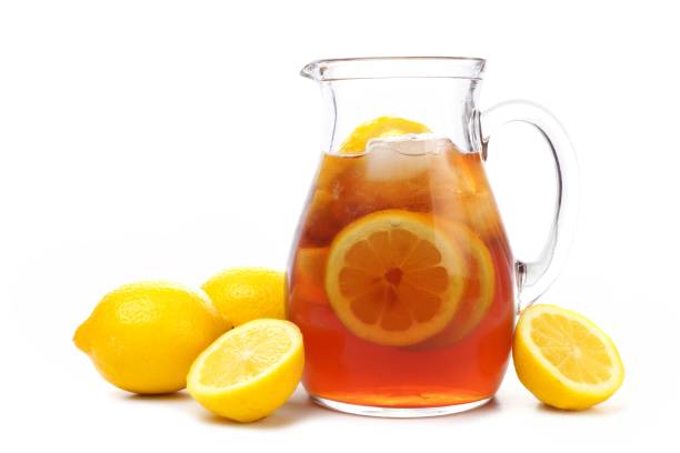 istock Pitcher of iced tea with lemons isolated on white 690507554