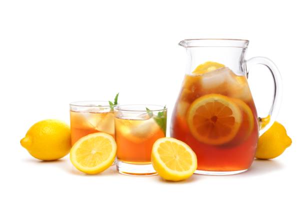 istock Pitcher of iced tea with two glasses isolated on white 690507590