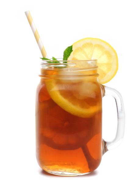 Mason jar glass of iced tea with straw isolated on white Mason jar glass of iced tea with straw isolated on a white background iced tea stock pictures, royalty-free photos & images