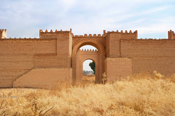 The outer walls of babylon seen just from the outside between the winter grass.