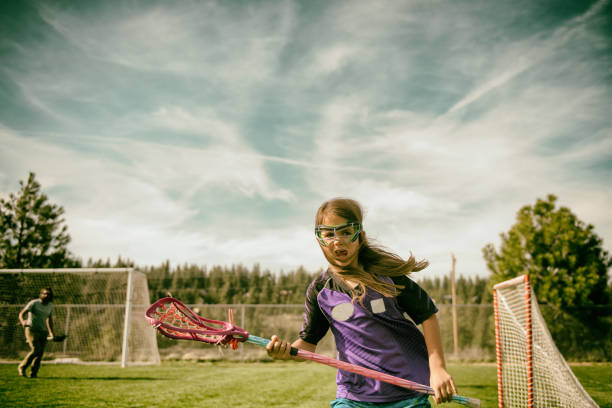 istock Young fierce girl playing lacrosse 690508210