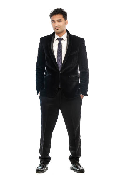 istock Young businessman with hands in pockets looking at camera 690513058