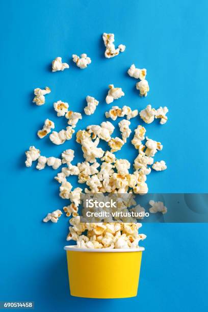 Popcorn Flat Lay Of Popcorn Cup On A Blue Background Top View Stock Photo - Download Image Now