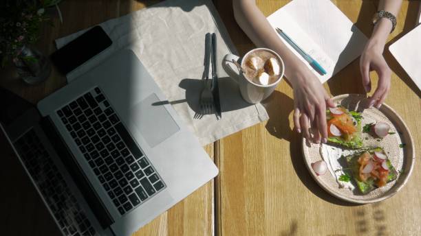 istock Students beautiful girl doing homework in cafe on breakfast, write a crib and drink coffee 690515246