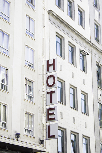 Hotel in town with sign, tourism and travel