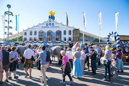 Munich, Germany - September 29, 2016:  Crowds of people at Oktoberfest on Munich's Theresienwiese. Outside view of Hofbrau Beer Tent on a sunny day.