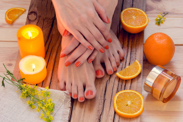 orange manicure around oranges and candles