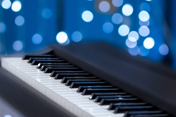 istock Piano keys on a blue bokeh background 690526202