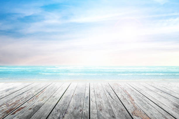istock old wood table top on blurred beach background. 690529510