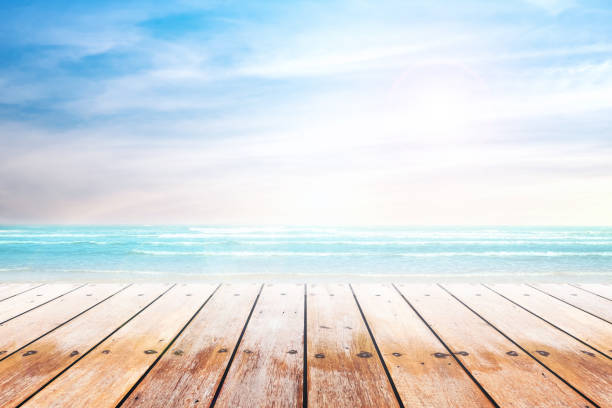 old wood table top on blurred beach background. stock photo