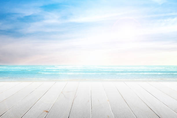 istock old wood table top on blurred beach background. 690529736