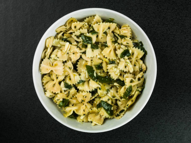 istock Bowl of Pasta Spinach and Pine Kernels Salad 690531856