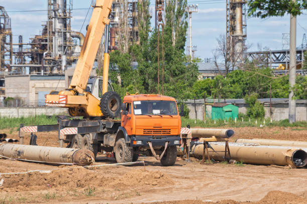 istock Construction work on pipe laying of pipeline into trench using a crane 690532272