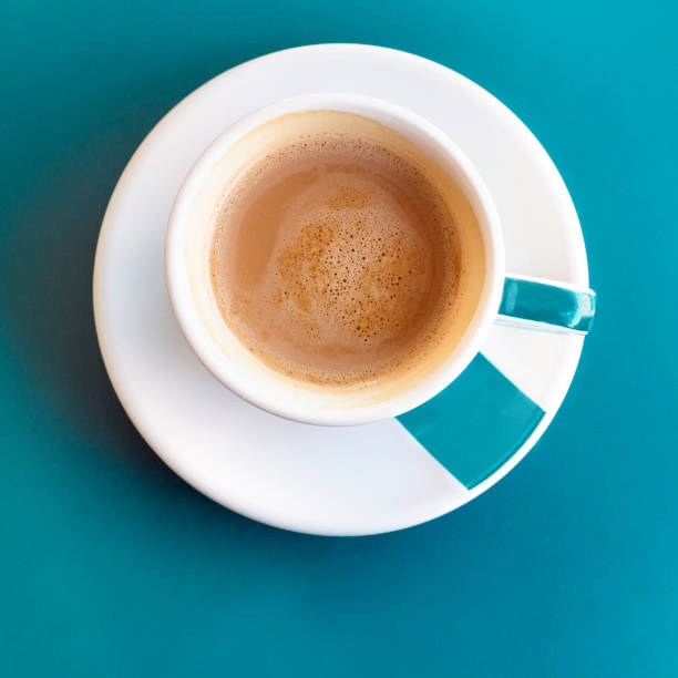 istock Cup of coffee on turquoise with copyspace 690532542