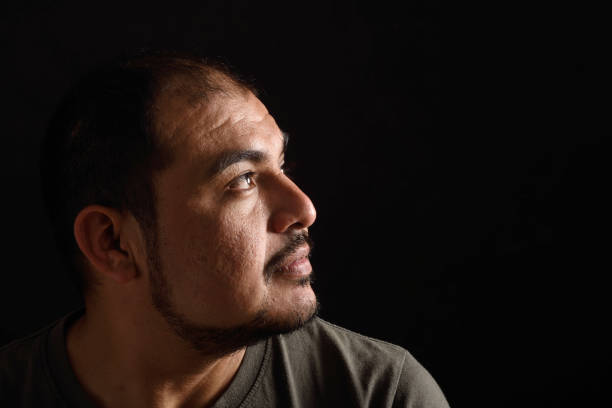 istock Portrait of a latin man on black background 690532884