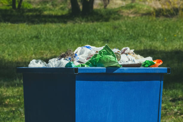 istock A crowded blue trash can on the street. 690535904