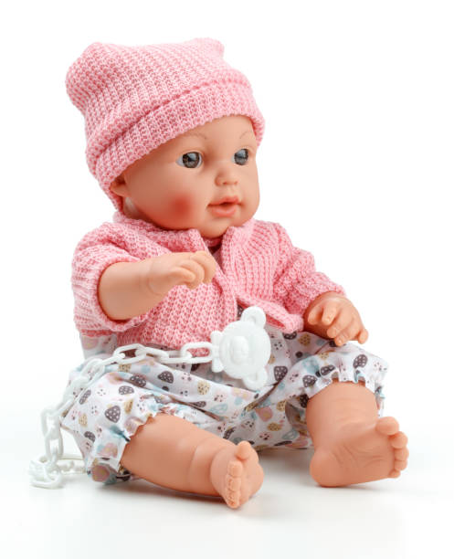 istock Toy doll child, in pink blouse with pacifier on isolated background 690536164