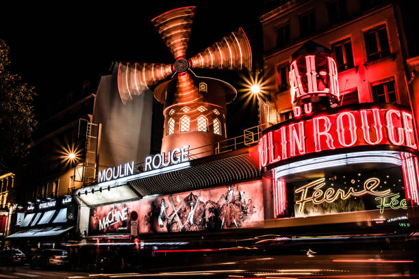 PARIS - OCT 29: The Moulin Rouge by night, on October 29, 2012 in Paris, France. stock photo