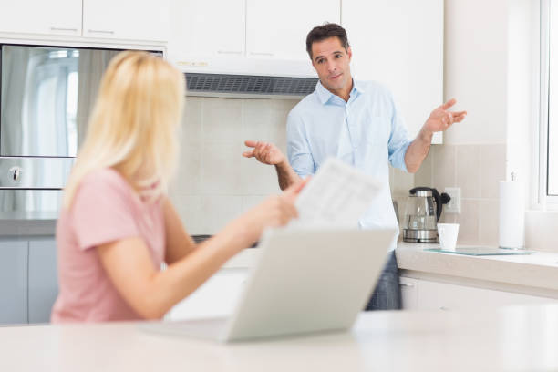 istock Couple with laptop and bill in the kitchen 690538954