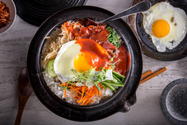 istock BI Bim Bap, Rice with Mixed Vegetables, top view with Hot Sauce in Cast Iron Pot 690539268