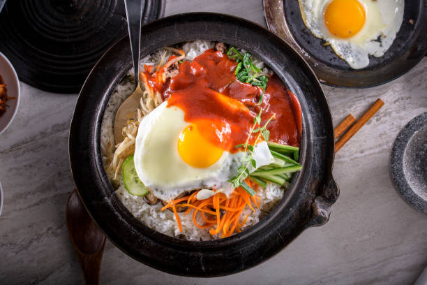 istock BI Bim Bap, Rice with Mixed Vegetables, top view with Hot Sauce in Cast Iron Pot 690539318