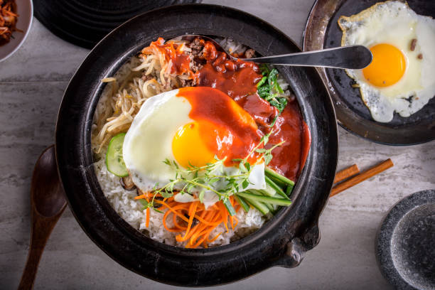 istock BI Bim Bap, Rice with Mixed Vegetables, top view with Hot Sauce in Cast Iron Pot 690539322