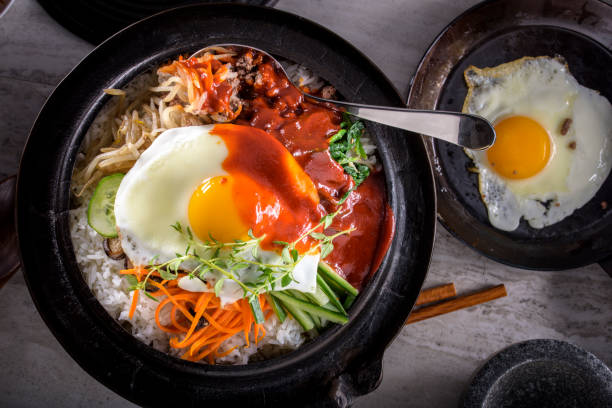 istock BI Bim Bap, Rice with Mixed Vegetables, top view with Hot Sauce in Cast Iron Pot 690539360