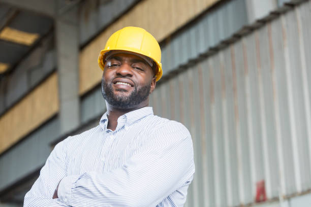 istock African American man in warehouse wearing hardhat 690551896