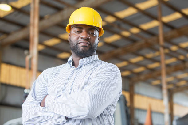istock African American man in warehouse wearing hardhat 690552178