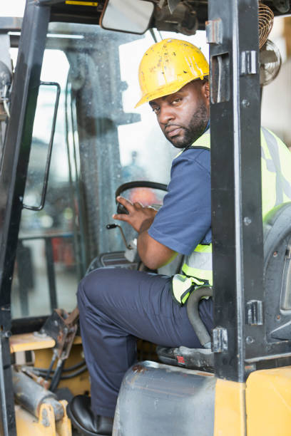 istock African American man driving forklift 690553366