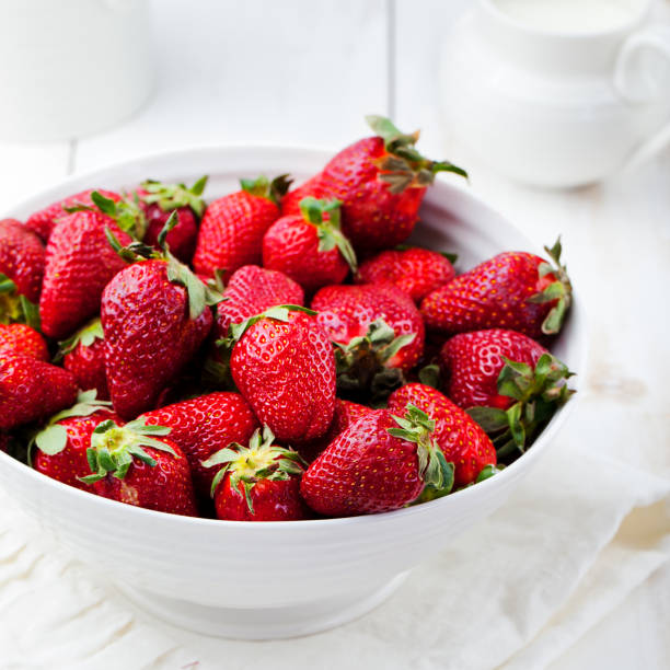 istock Fresh strawberry in a white bowl Rustic background 690558300