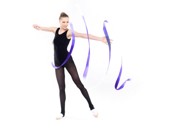istock Smiling young rhythmic gymnast training with blue ribbon isolated on white 690560764