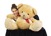Large yellow teddy bear with Russian indoor girl model isolated