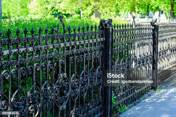 Old Cast Iron Spiked Fence In A Park Stock Photo - Download Image Now - Metal, Fence, Grid Pattern