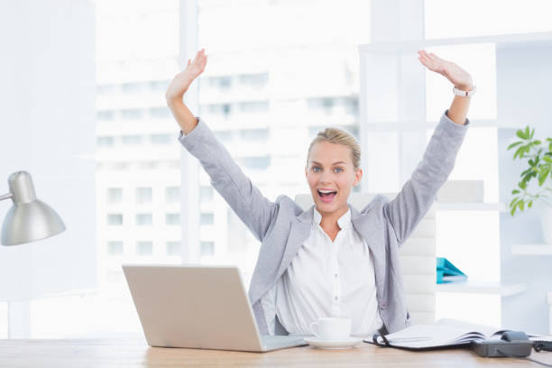 istock Happy businesswoman with raised arms 690588372
