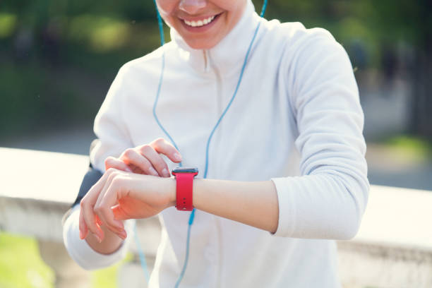 istock Sportswoman checking pulse on smart watch 690592054