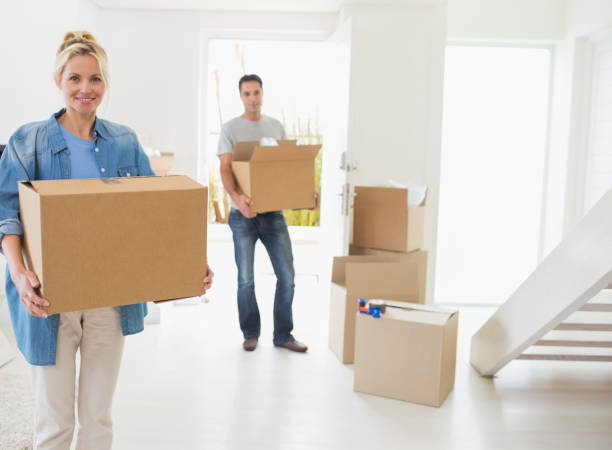 istock Smiling couple moving together in a new house 690593706