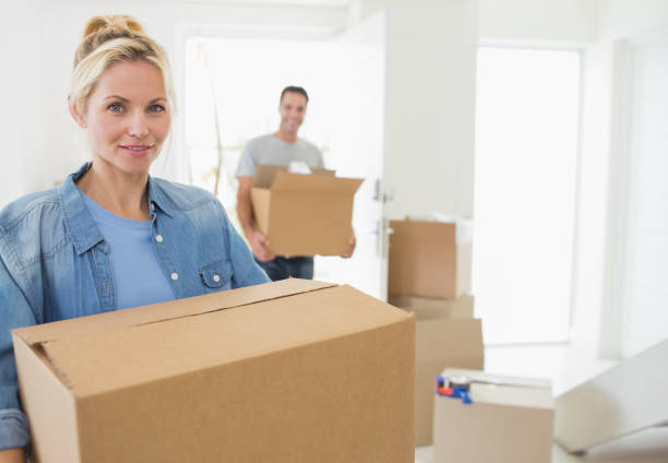 istock Smiling couple moving together in a new house 690593818