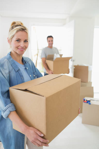 istock Smiling couple moving together in a new house 690593830
