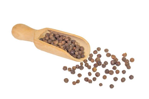 istock allspice in a wooden bowl. Black pepper. isolated on white background. 690593894