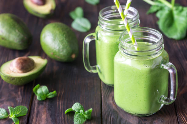 Avocado and spinach smoothies stock photo