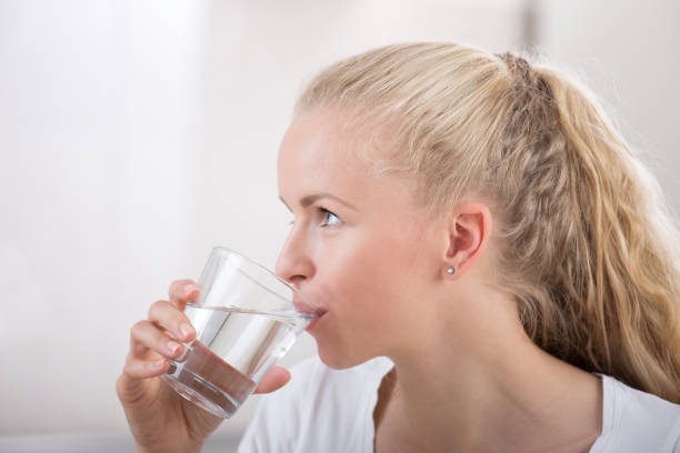 istock Young woman drinking water 690598998