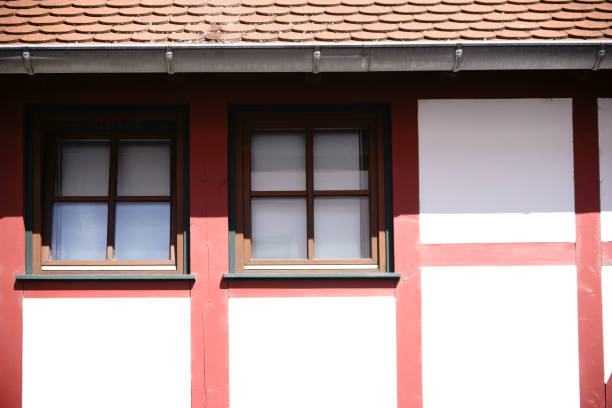 istock Half-timbered house facade with windows under the roof 690603112