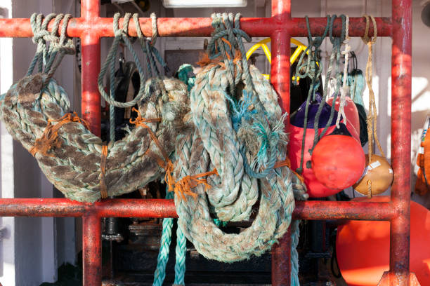 istock Worn old rope fenders on a ship 690603142