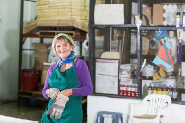 istock Senior woman working in food processing plant 690603332